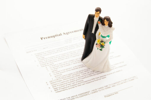 cake-topper wedding couple and a pre-nuptial agreement